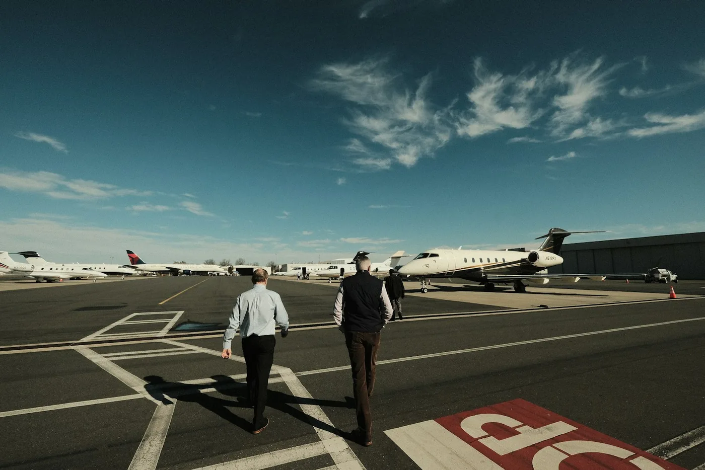 Travelers walking to a private jet